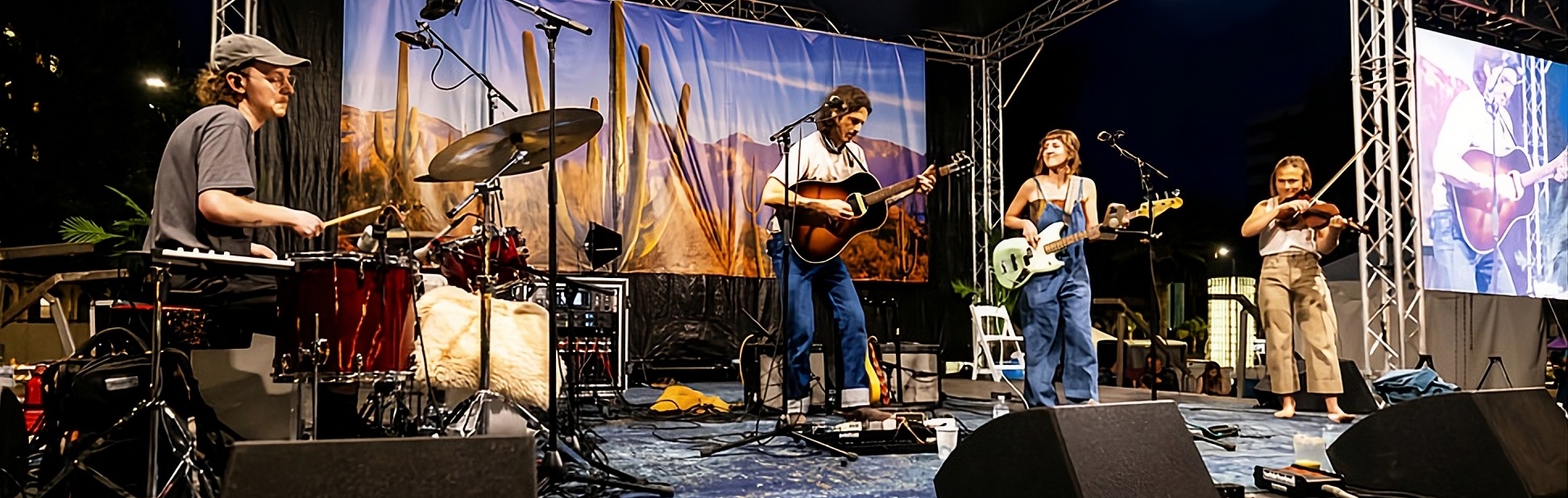 Musicians performing live on stage at the Tucson Folk Festival