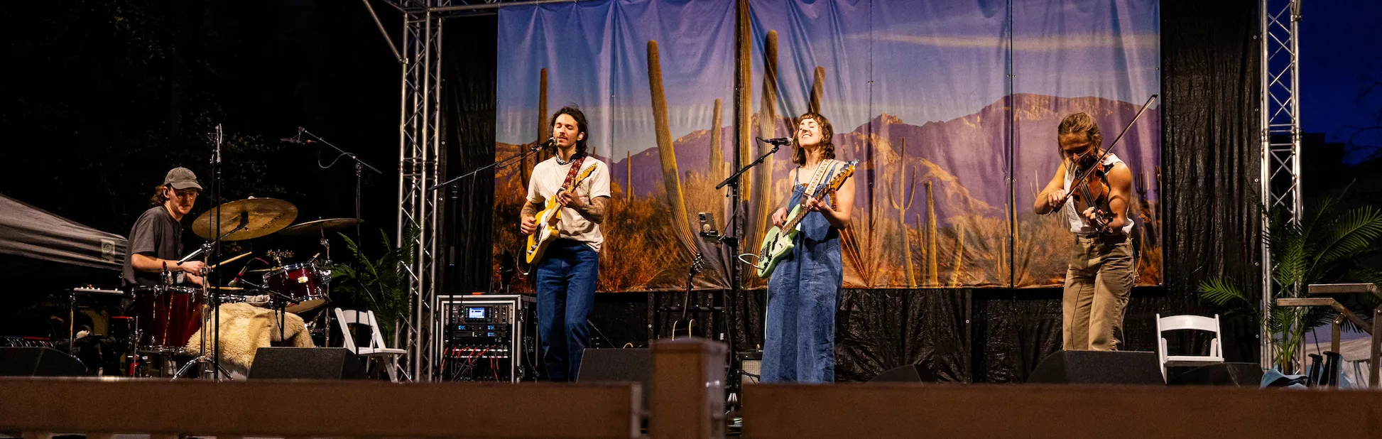 Musicians performing live on stage at the Tucson Folk Festival